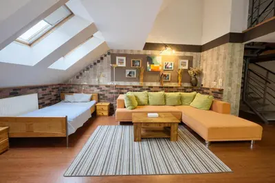 a living room with a couch and a bed at Botič Gardenia Residences Prague in Prague