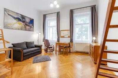 a living room with a couch and a table at Charming Loft Studio Near Metro & Old Town in Prague