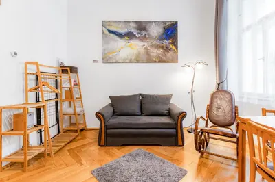 a living room with a couch and a table at Charming Loft Studio Near Metro & Old Town in Prague