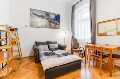 a living room with a chair and a couch at Charming Loft Studio Near Metro & Old Town in Prague