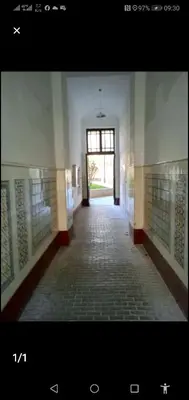 a hallway of a building with a window and a corridor at Riverside Praha Apartament in Prague