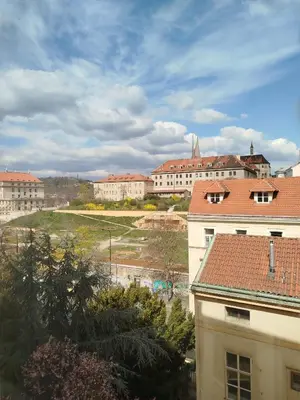 a view of a city with buildings in the background at Riverside Praha Apartament in Prague