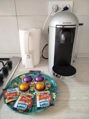 a counter top with a plate of snacks and a coffee maker at Riverside Praha Apartament in Prague