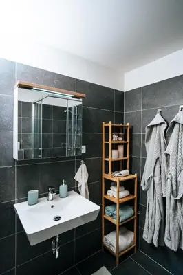 a bathroom with a sink and a mirror at Blue Apartment - Vršovice in Prague