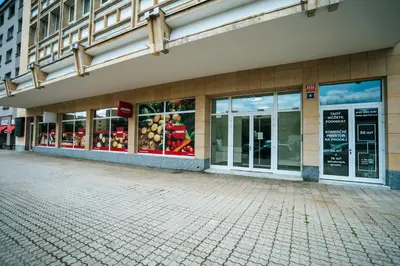 a store front of a building with glass windows at Blue Apartment - Vršovice in Prague