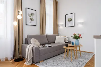 a living room with a gray couch and a table at Prague Days - Fully Equipped Studio near Wenceslas Square in Prague