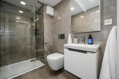 a bathroom with a toilet and a shower and a sink at Prague Days - Fully Equipped Studio near Wenceslas Square in Prague
