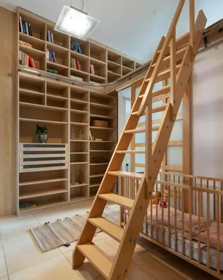 a staircase in a room with bookshelves at Prague Days - Family Friendly Apartment with AC and Netflix in Old Town in Prague