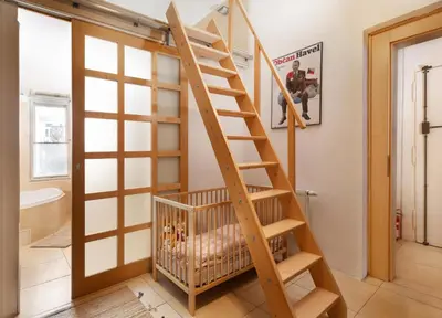 a staircase in a room with a crib at Prague Days - Family Friendly Apartment with AC and Netflix in Old Town in Prague