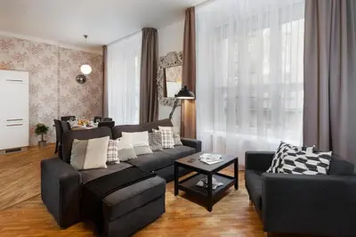 a living room with a couch and a table at Prague Days - Family Friendly Apartment with AC and Netflix in Old Town in Prague