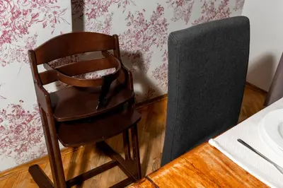 a wooden chair sitting next to a table at Prague Days - Family Friendly Apartment with AC and Netflix in Old Town in Prague