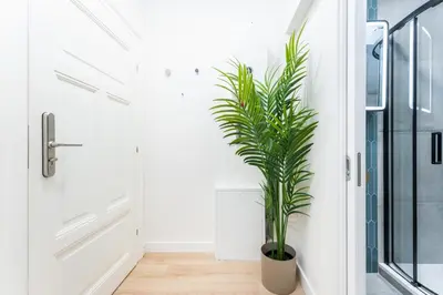 a plant in a hallway next to a door at Rentero Central Loft Apartment in Prague