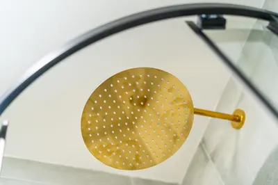 a gold strainer on top of a glass rack at Rentero Central Loft Apartment in Prague