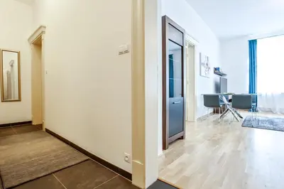 a room with a hallway with a door and a table at Rhapsody in Prague
