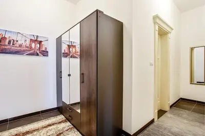 a wooden elevator in a room with a mirror at Rhapsody in Prague