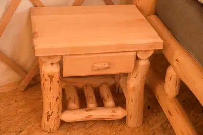a wooden stool sitting next to a chair at 02 JURTA hnědá v jablečném sadu