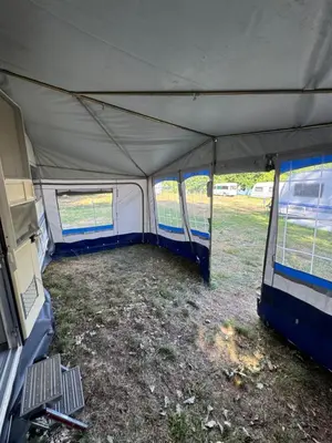 a large tent is set up in a field at Karavan Ždáň in Slapy
