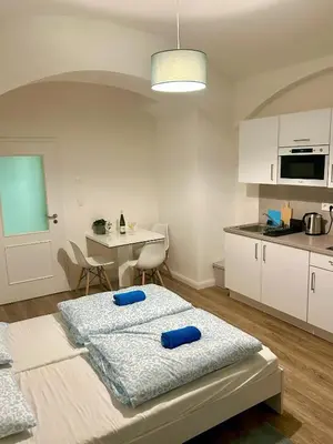 a kitchen with two pillows on top of a bed at Cozy Budget Studio by F&S in Prague