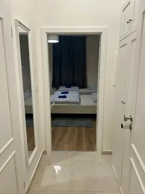a doorway to a bedroom with a bed in a room at Cozy Budget Studio by F&S in Prague