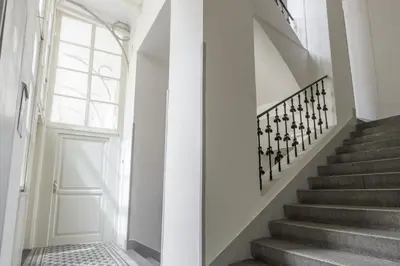 a hallway with stairs and a white door at Apartment Jindrisska in Prague