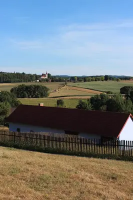 a barn in a field with a wooden fence at Country house - Slapy/Pazderny in Žďár