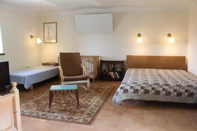 a bedroom with a bed and a couch and a chair at Country house - Slapy/Pazderny in Žďár
