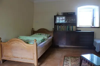 a bedroom with a wooden bed and a book shelf at Country house - Slapy/Pazderny in Žďár