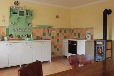 a kitchen with a table and a stove in it at Country house - Slapy/Pazderny in Žďár