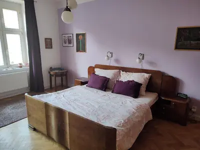 a bedroom with a large bed with purple pillows at Prague-2 Vinohrady Apartment in Prague