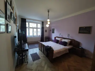 a bedroom with a bed and a tv in it at Prague-2 Vinohrady Apartment in Prague