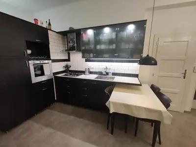 a kitchen with a sink and a table with chairs at Prague-2 Vinohrady Apartment in Prague