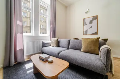 a living room with a couch and a table at Blueground Holešovice city view nr Vltava PRG-51 in Prague