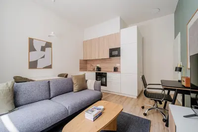 a living room with a couch and a table at Blueground Holešovice city view nr Vltava PRG-51 in Prague