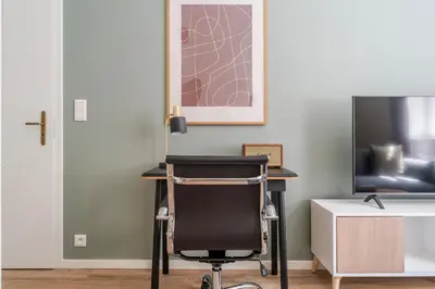a desk with a chair next to a tv at Blueground Holešovice city view nr Vltava PRG-51 in Prague