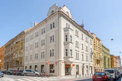 a large white building on the corner of a street at Blueground Holešovice balcony nr Vltava PRG-55 in Prague
