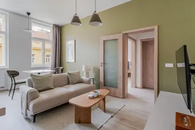 a living room with a couch and a table at Blueground Nusle city view nr Vysehrad PRG-73 in Prague