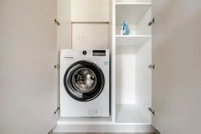 a washer and dryer in a white laundry room at Blueground Nusle city view nr Vysehrad PRG-73 in Prague