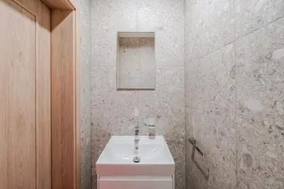 a white bathroom with a sink and a mirror at Blueground Nusle city view nr Vysehrad PRG-73 in Prague