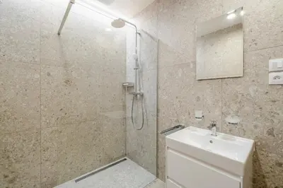 a bathroom with a shower and a sink at Blueground Nusle city view nr Vysehrad PRG-73 in Prague