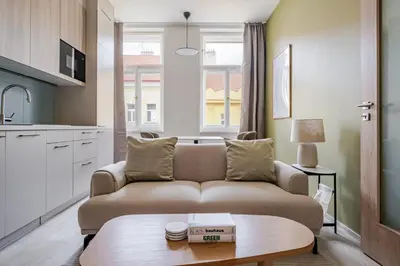 a living room with a couch and a table at Blueground Nusle city view nr Vysehrad PRG-73 in Prague