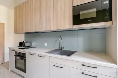 a kitchen with a sink and a microwave at Blueground Nusle city view nr Vysehrad PRG-73 in Prague