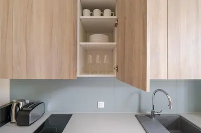 a kitchen with a sink and a cupboard with eggs in it at Blueground Nusle city view nr Vysehrad PRG-73 in Prague