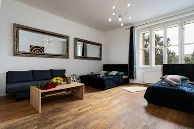 a living room with a couch and a table at Aurora Estate Elegance in Prague