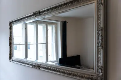 a mirror hanging on a wall with a window at Aurora Estate Elegance in Prague