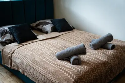 a bed in a bedroom with two pillows on it at Aurora Estate Elegance in Prague