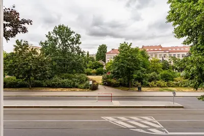 an empty street with a bench on the side of a road at Aurora Estate Elegance in Prague