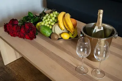a tray of fruit and vegetables on a table with two wine glasses at Aurora Estate Elegance in Prague