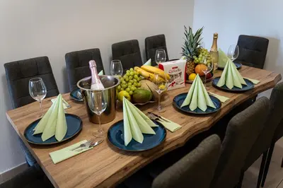 a wooden table with plates of fruit and wine glasses at Aurora Estate Elegance in Prague