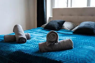 a bed with towels and pillows on it at Aurora Estate Elegance in Prague