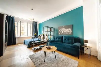 a blue living room with a couch and a table at Central Riverside 2BD Apt by Vltava & Theater in Prague